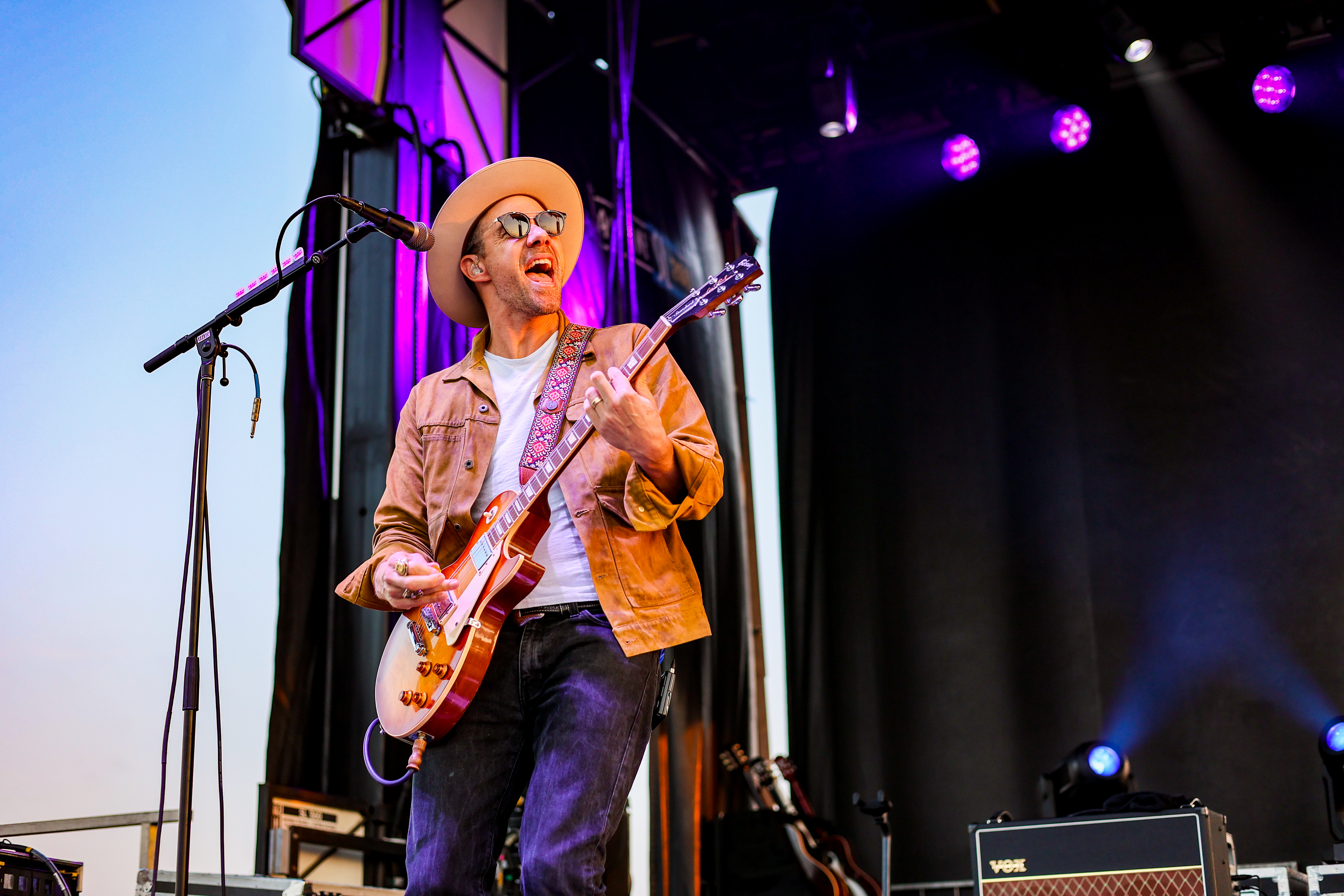 man plays guitar on stage